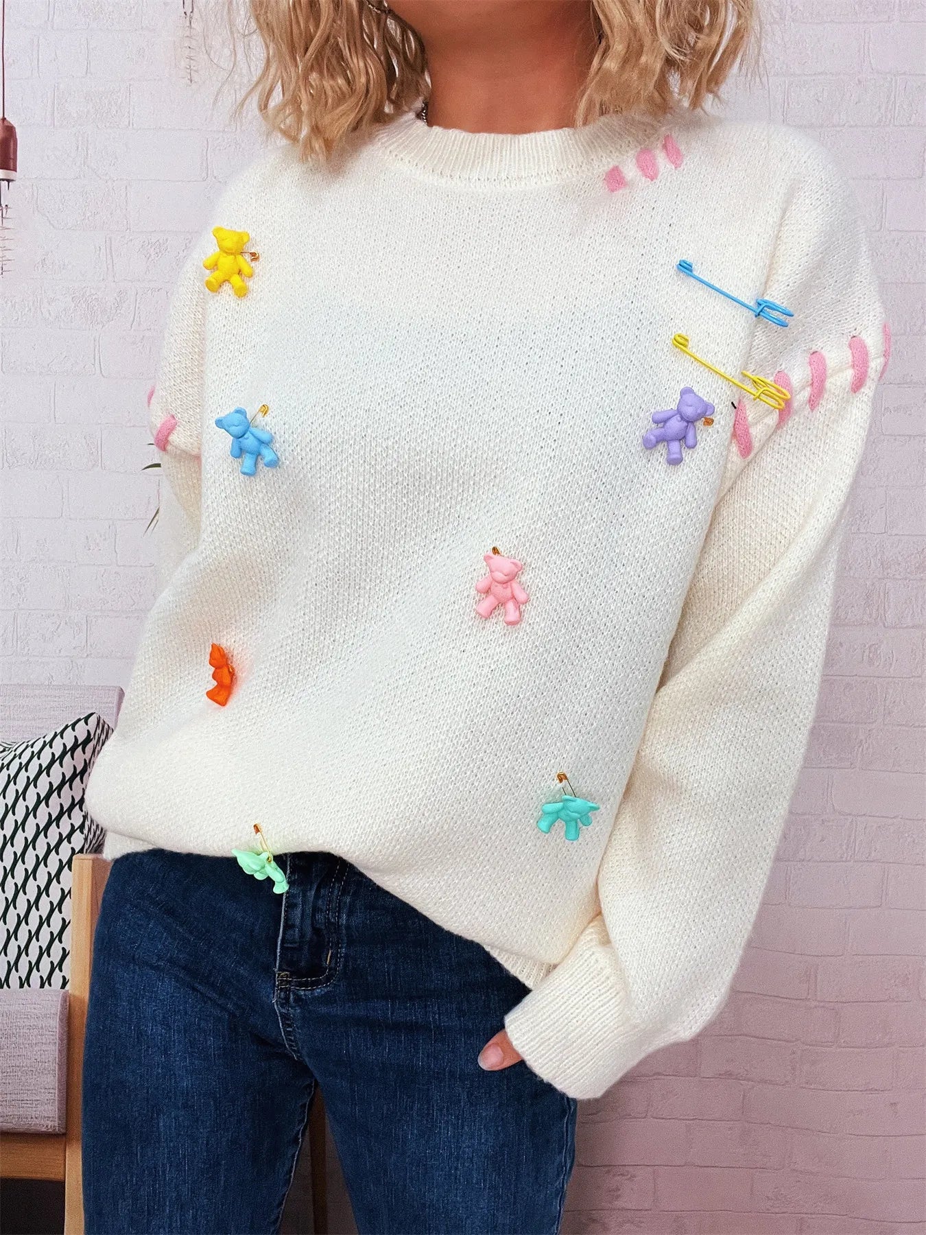 Cream round-neck sweater with colorful bear appliques on front and sleeves
