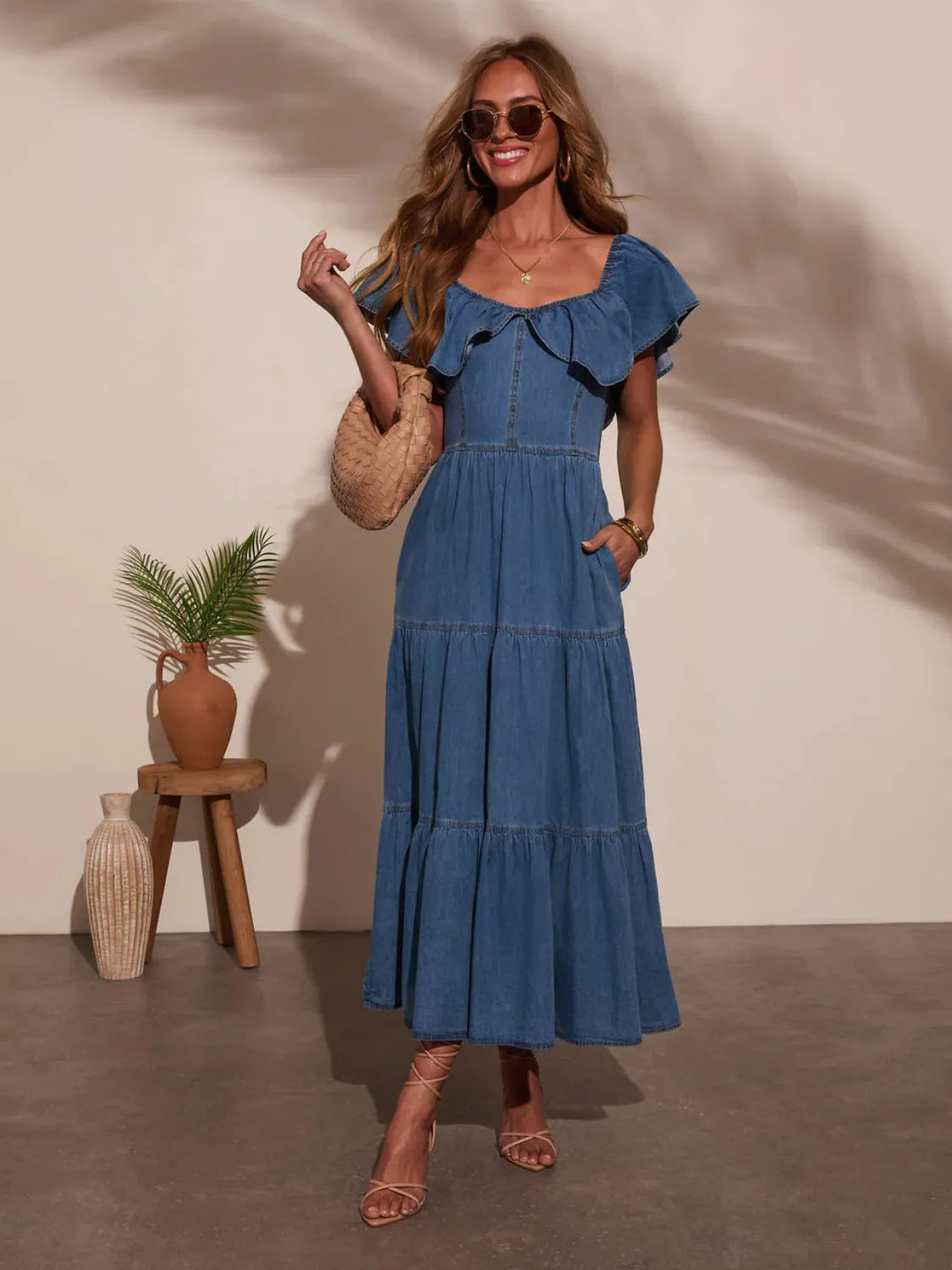 Dark blue tiered denim off-shoulder dress with layered ruffles and a gathered bodice