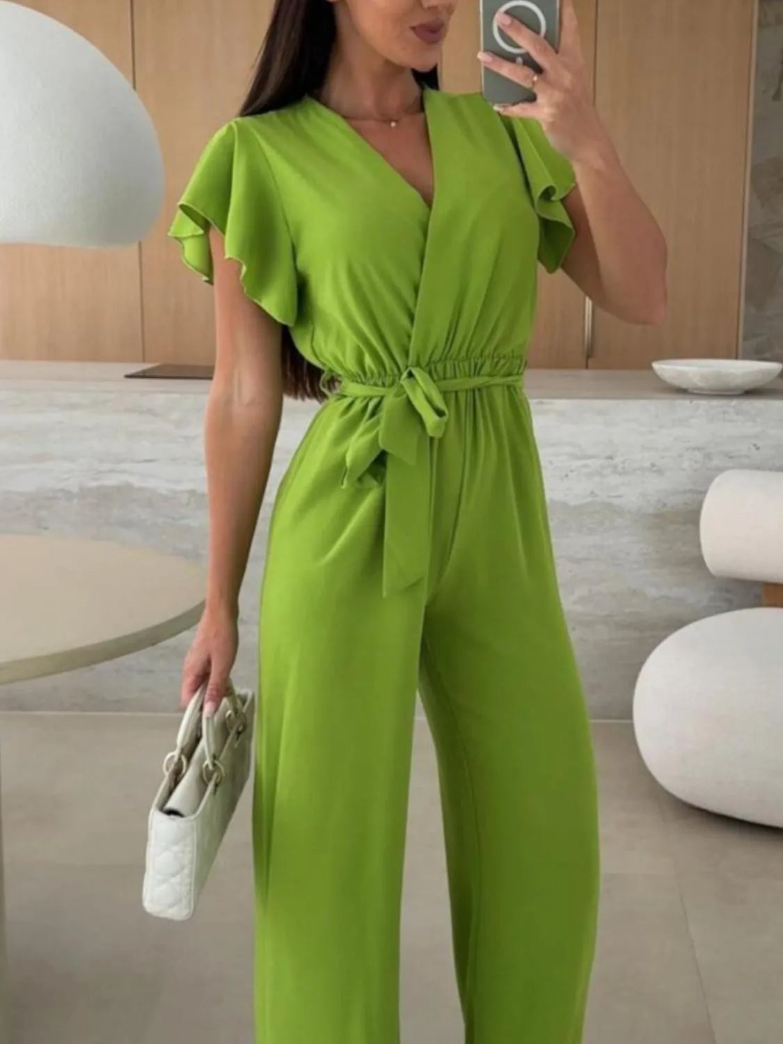 Lime green ruffle sleeve wide-leg jumpsuit with V-neck and tie waist