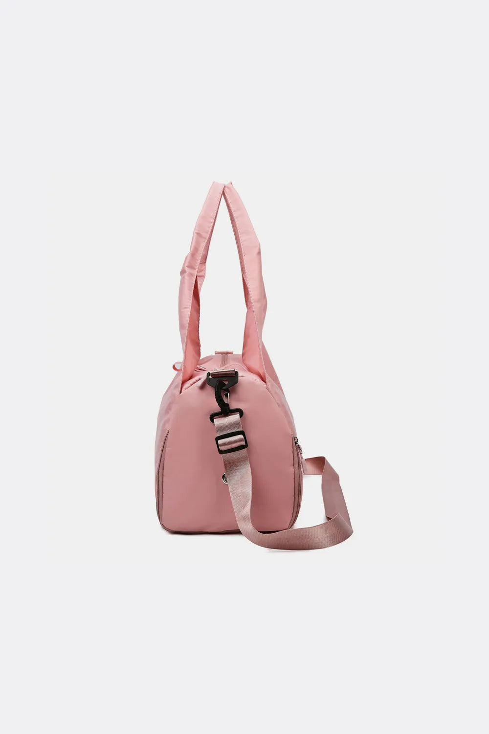 Dusty pink waterproof travel tote bag with top handle, side strap, and zipper trim.