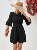 Black round-neck dress with tie belt and flounce sleeves, short A-line skirt