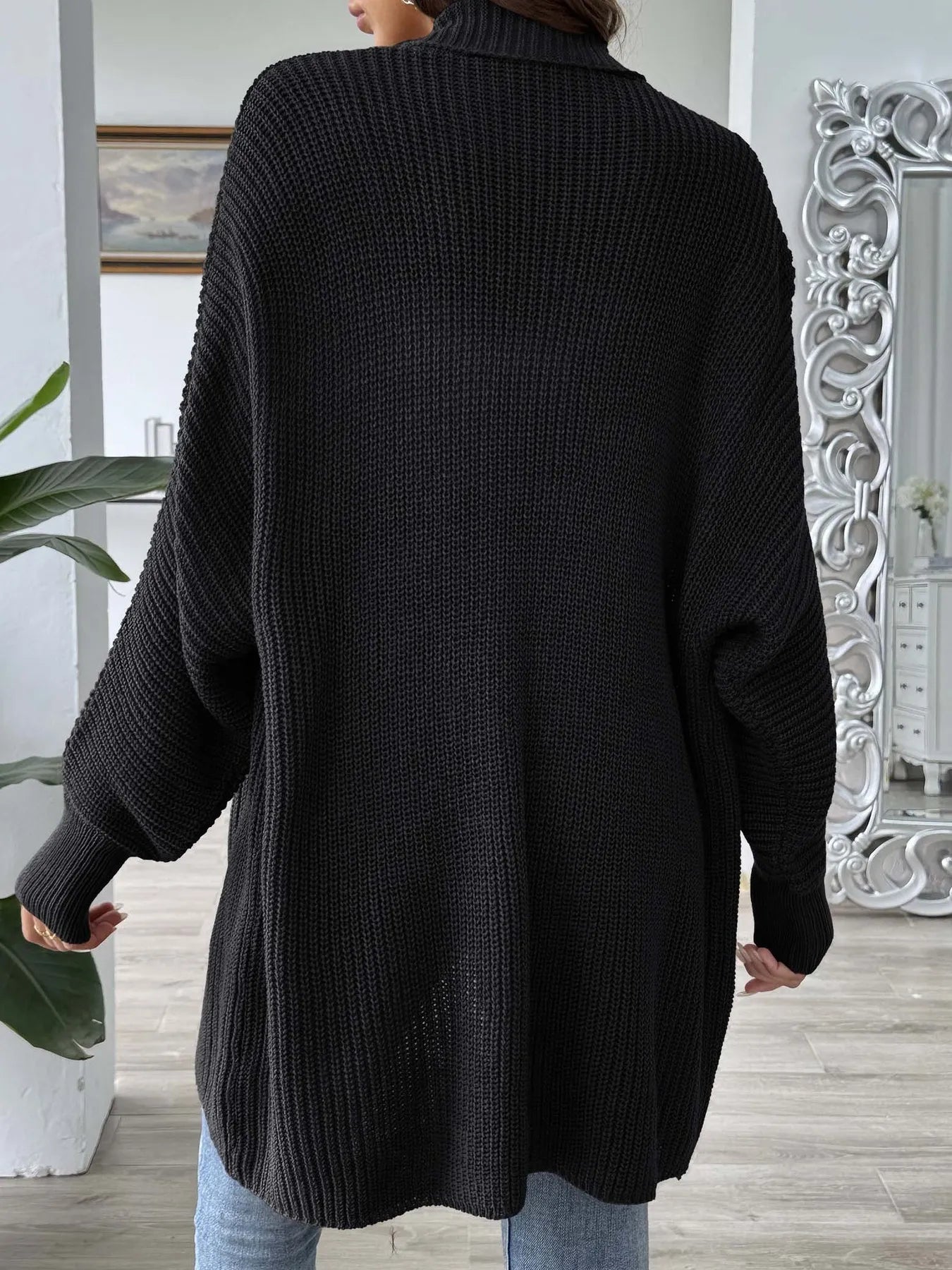 Black oversized knit open-front cardigan with long sleeves and chunky texture