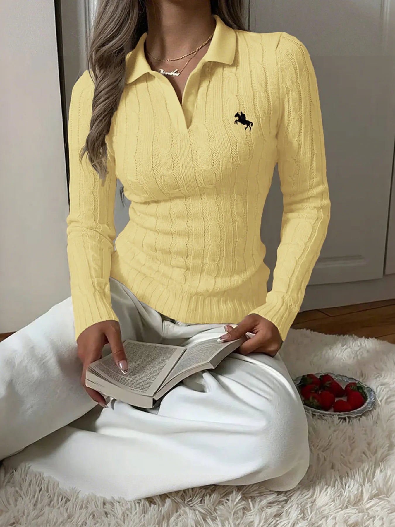 Yellow cable-knit long sleeve sweater with collared neckline and embroidered horse logo