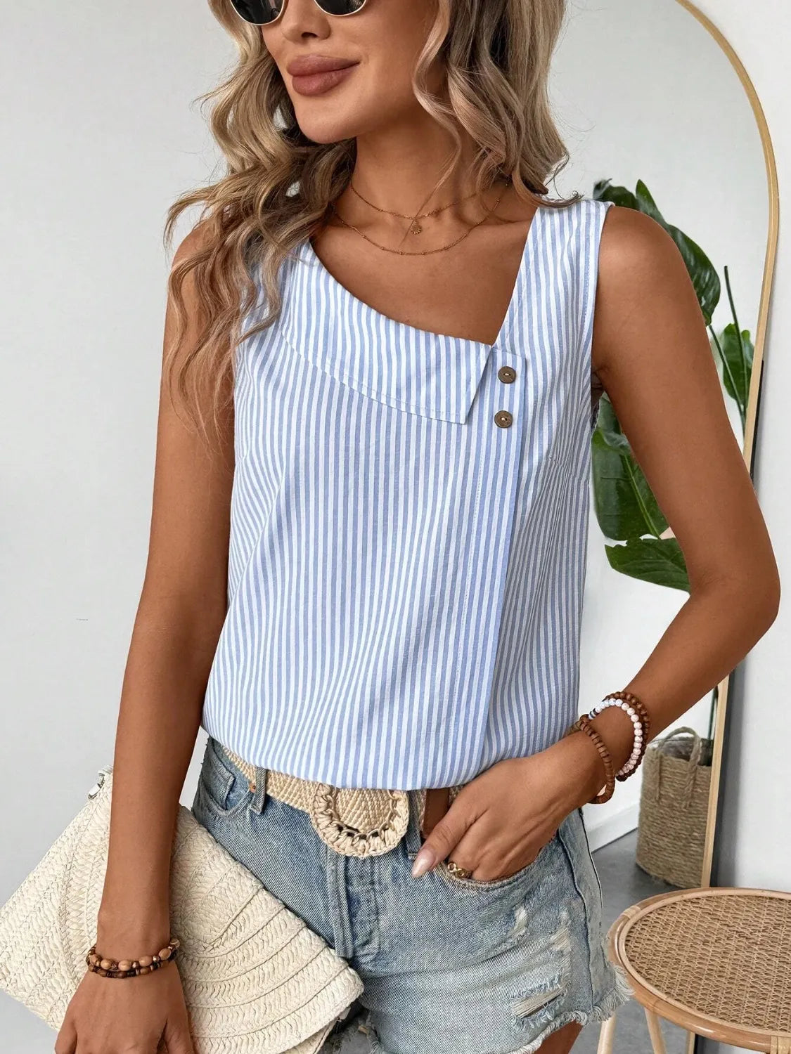 Light blue striped asymmetrical tank top with decorative button placket