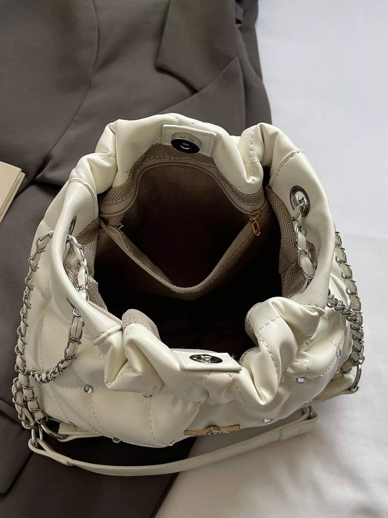 Quilted white PU shoulder bag with silver chain strap and interior pocket