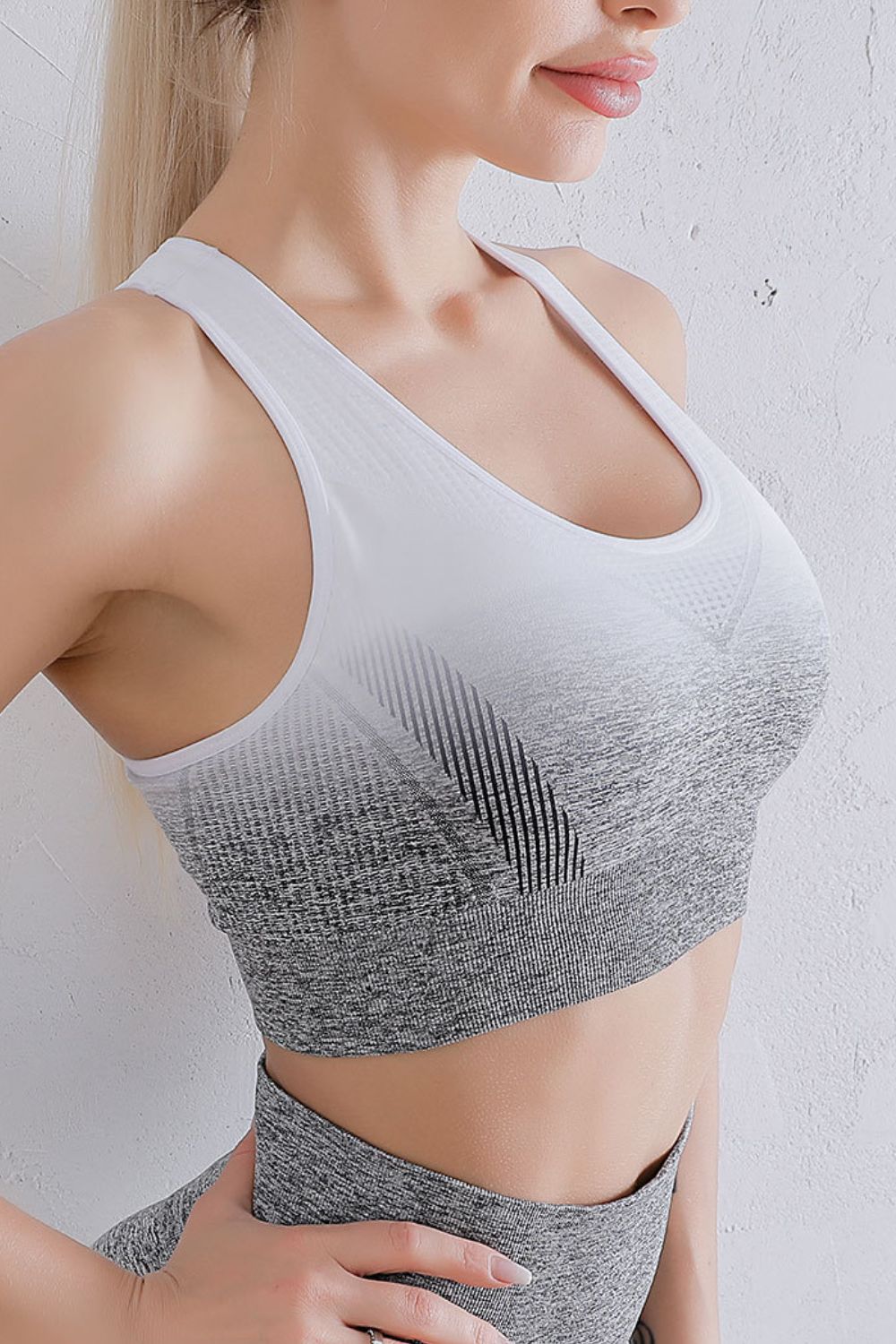 Grey and black gradient racerback sports bra with scoop neckline and breathable knit