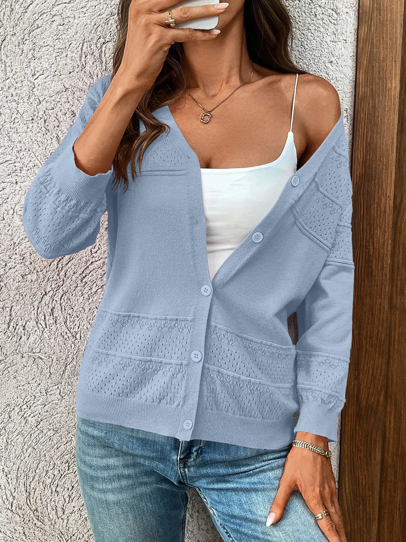 Light blue textured cardigan with button placket, 3/4 sleeves, and patch pockets