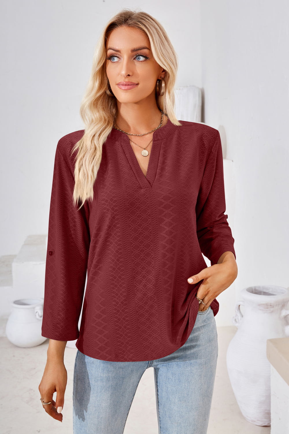 Burgundy V-neck blouse with roll-tap sleeves and textured pattern