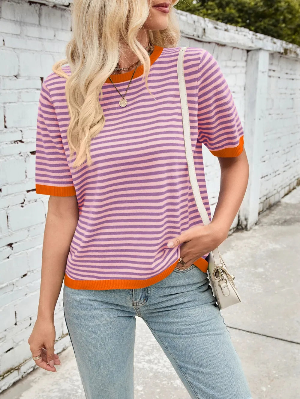 Striped knit top, purple-and-white stripes with orange ribbed contrast trim at neck and cuffs