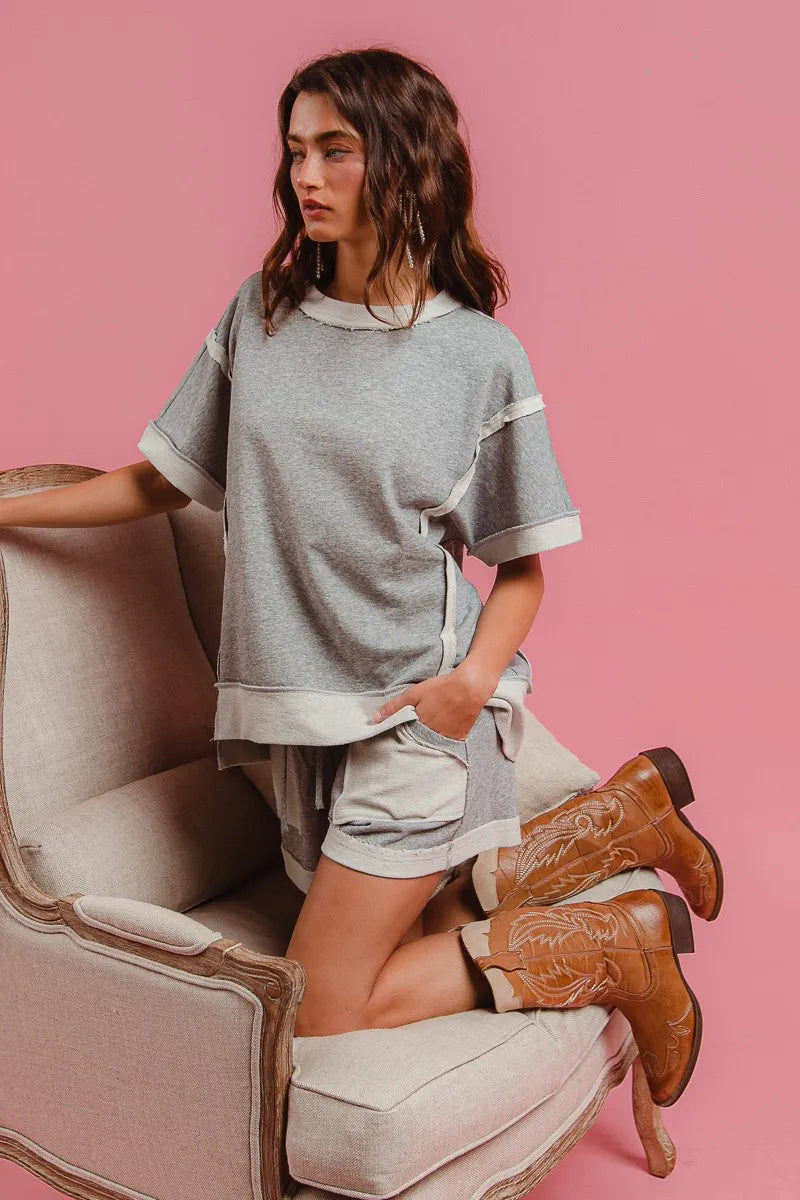 Heather grey terry knit shorts with elastic waist, drawstring, and side pocket flaps