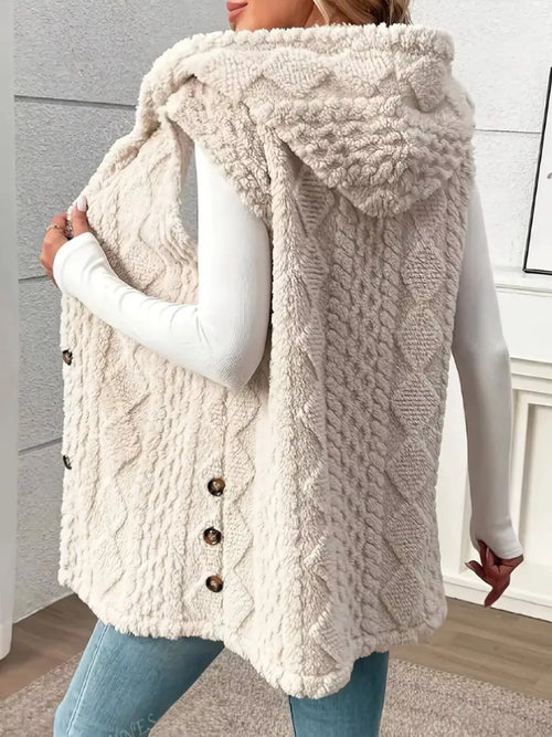 Beige sherpa hooded vest coat with draped hood and button placket, textured fabric.
