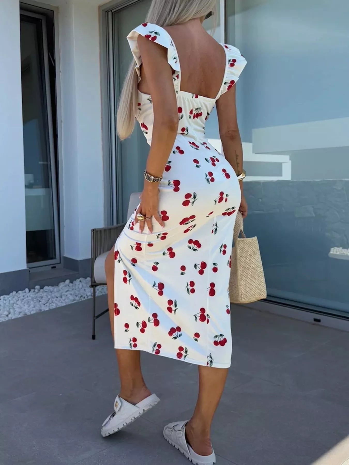 White midi dress with cherry print, open back, ruffled straps, thigh slit