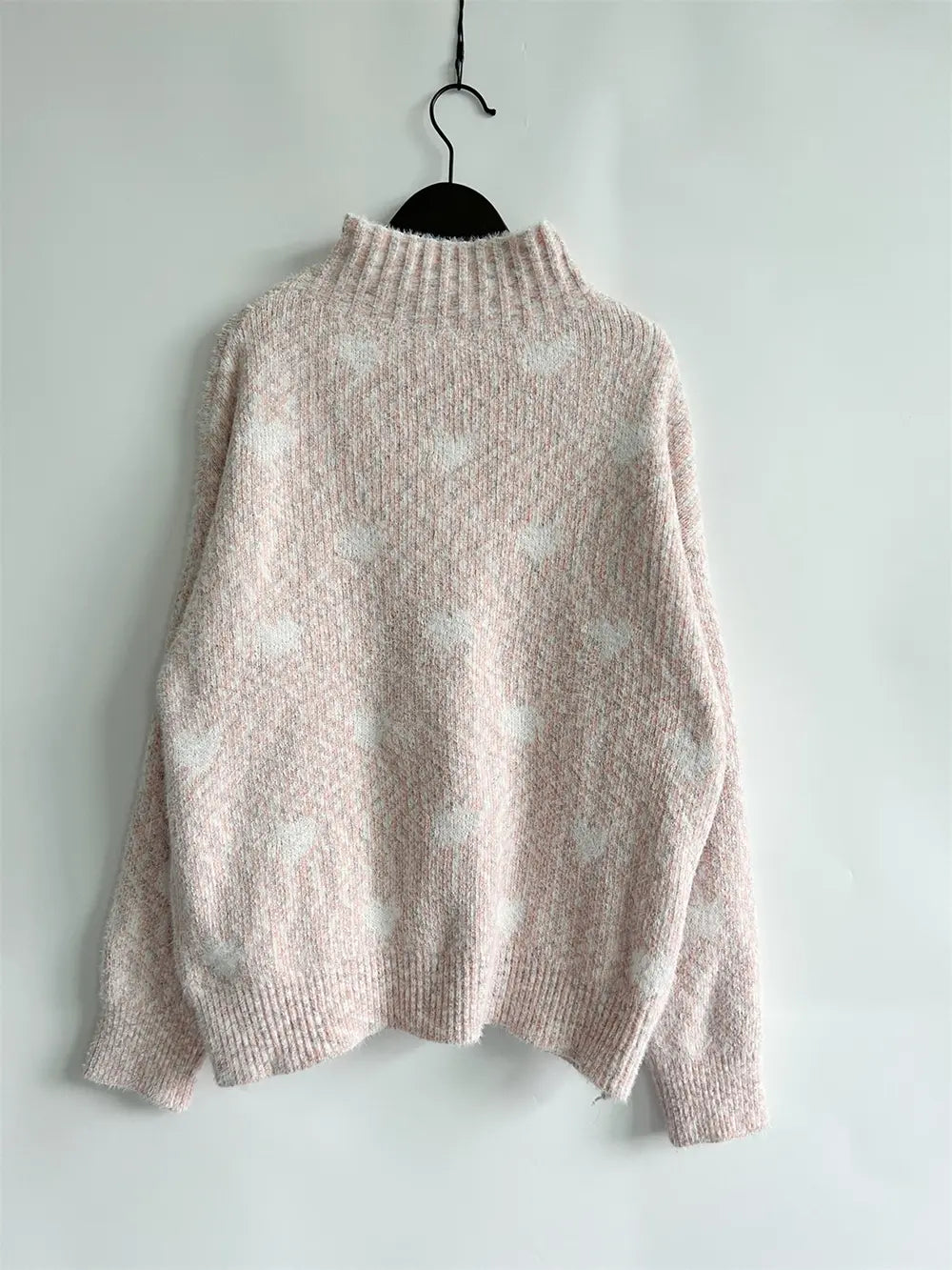 Light pink heathered knit turtleneck sweater with drop shoulders and high collar