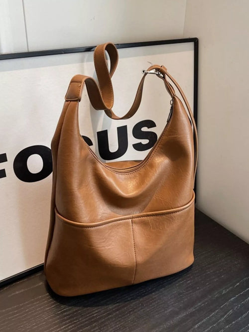 Brown hobo-style shoulder bag with adjustable strap and open top
