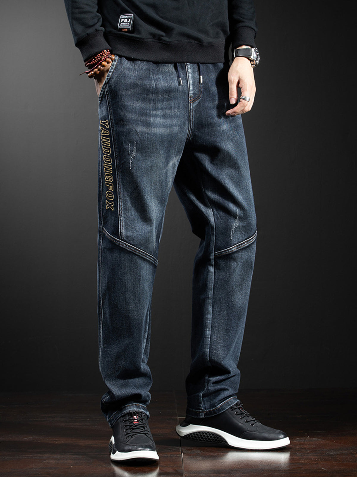 Relaxed-fit cotton jeans, dark wash, vertical logo graphic on left leg