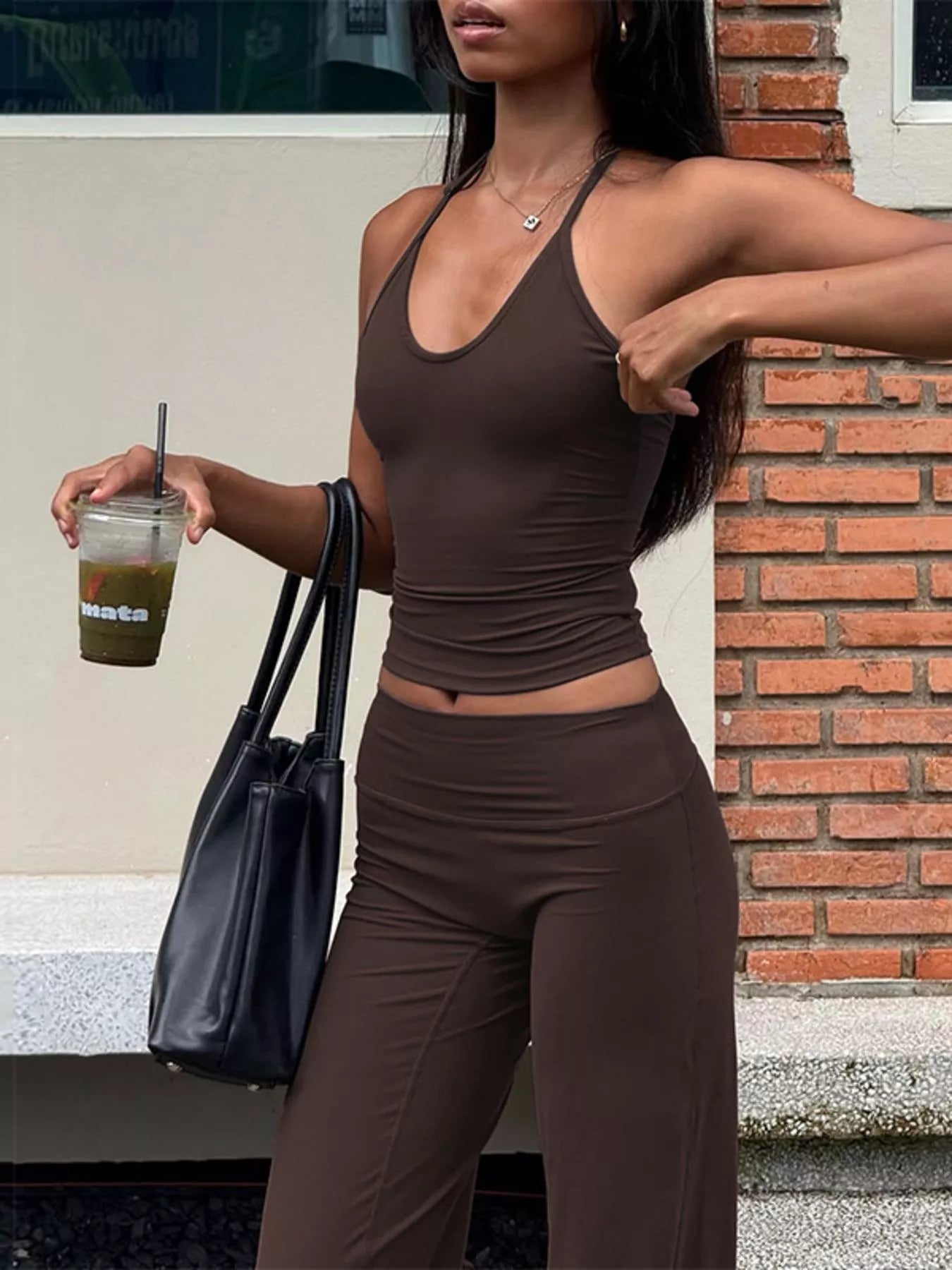 Halter neck crop top and flared pants set in dark brown, sleeveless and fitted