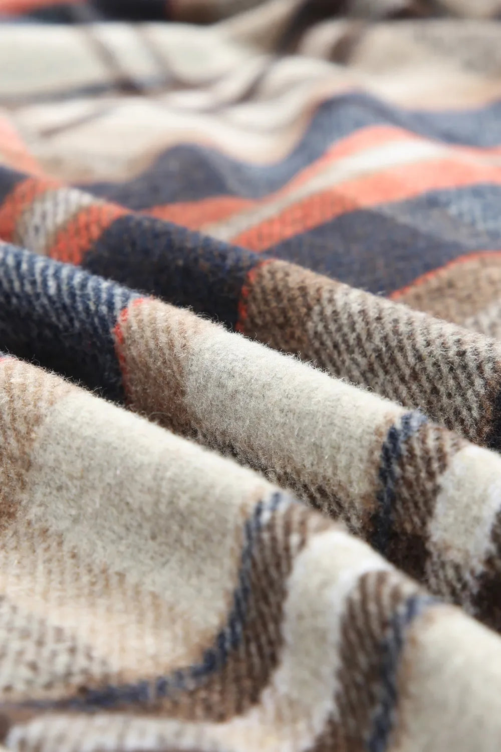 Plaid jacket fabric close-up, beige and navy weave with orange line details