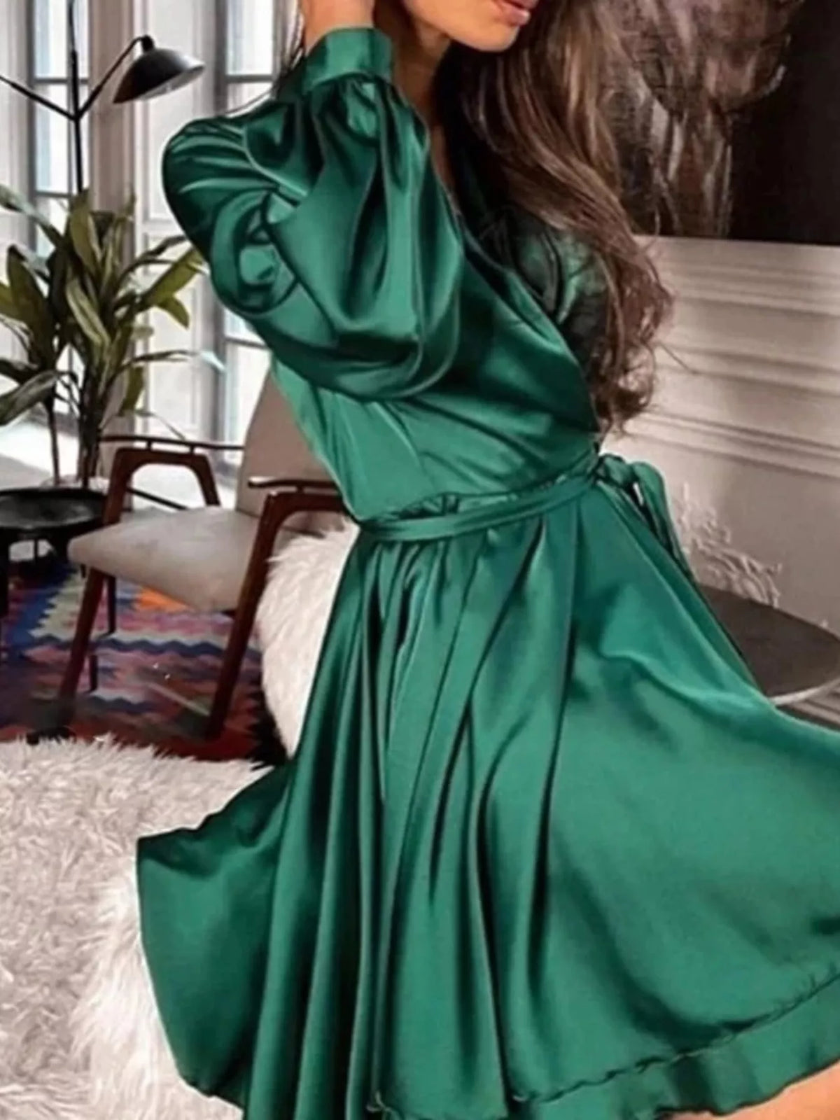 Green satin surplice mini dress with long sleeves and belt-tied waist
