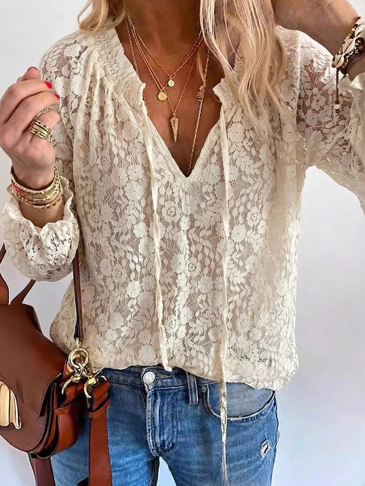 White lace V-neck long-sleeve blouse with openwork pattern and front tie