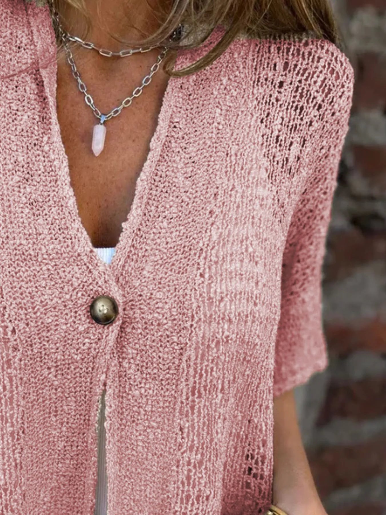 Openwork V-neck one-button cardigan with short sleeves in dusty pink, side close-up.