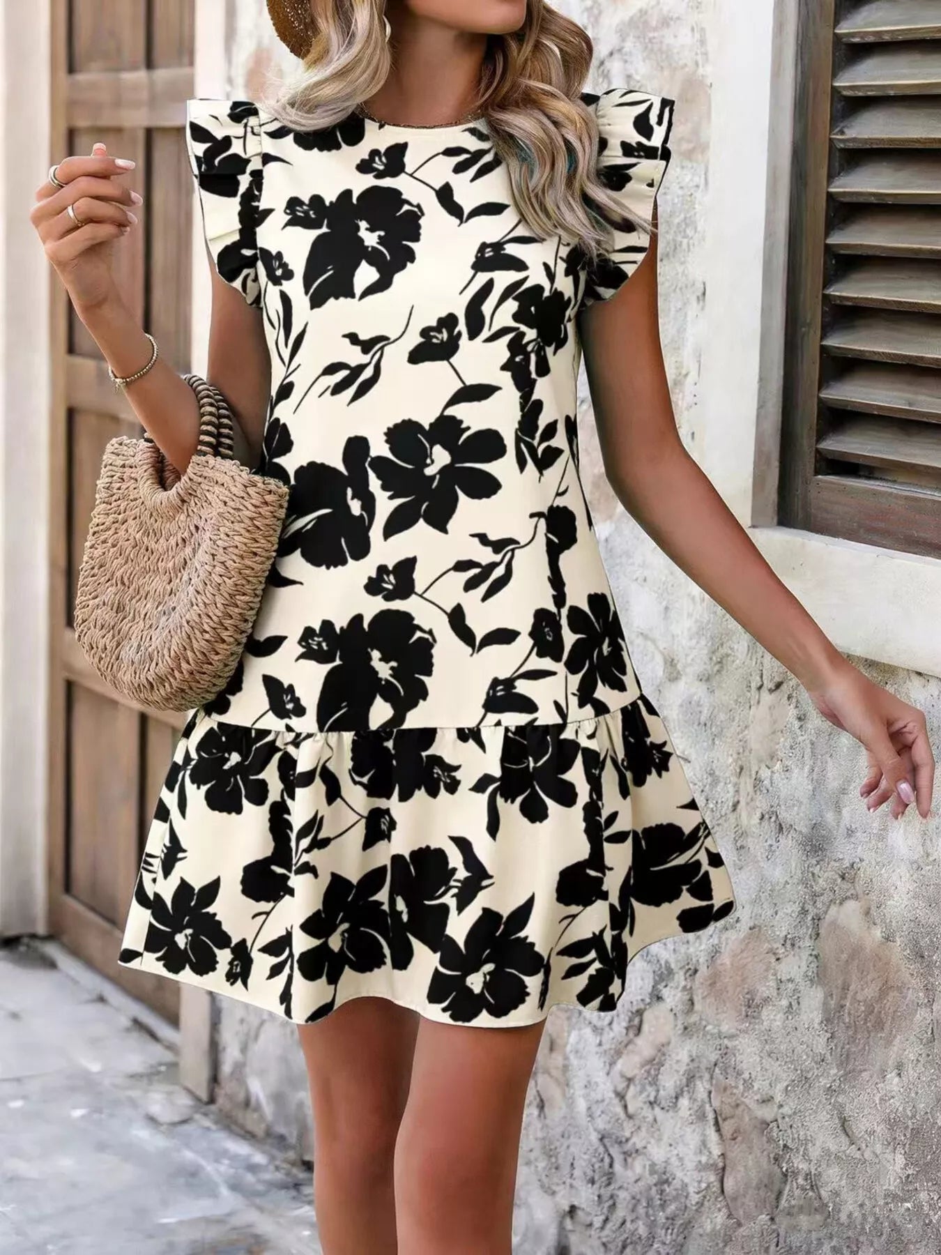 Cream black-floral mini dress with ruffle sleeves and tiered skirt, front view