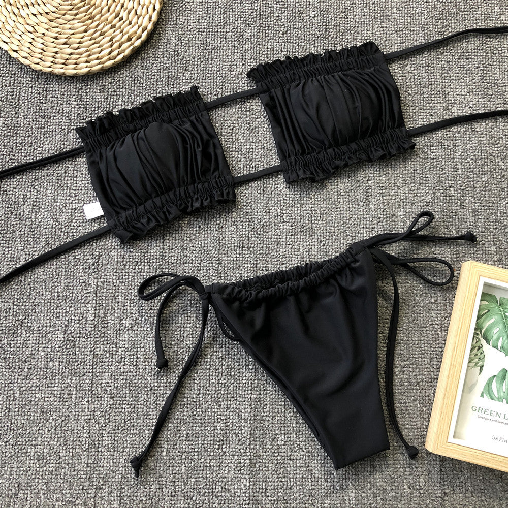 Black ruched bikini set with frill trim: bandeau top and tie-side bikini bottoms