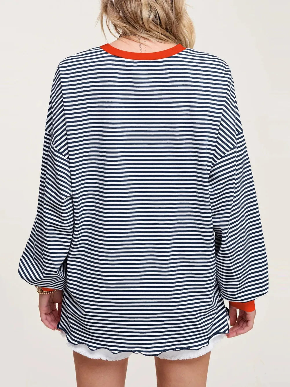 Contrast striped long sleeve sweatshirt in blue and white, back view with orange trim at hem