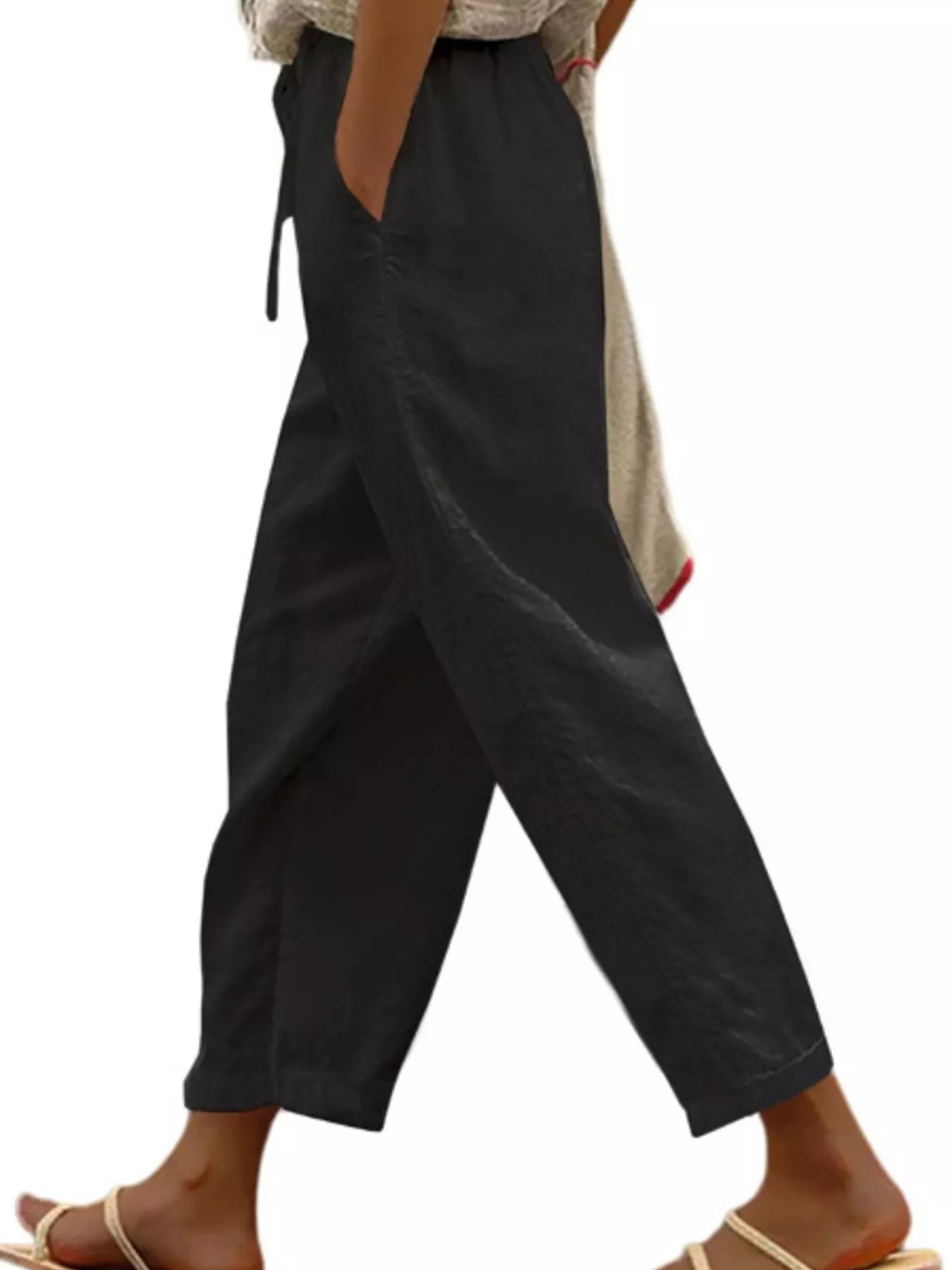 Black cropped drawstring pants with side pockets, relaxed wide-leg fit
