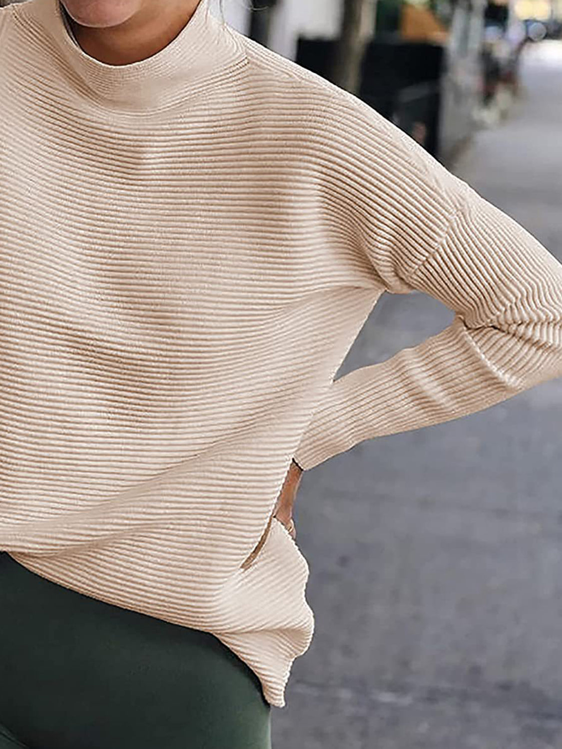 Sand ribbed mock neck long sleeve sweater, angled view of shoulder and sleeve