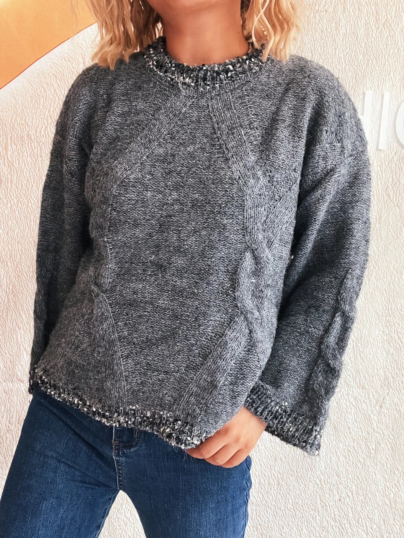 Dark gray round-neck sweater with contrast knit trim on collar, cuffs, and hem