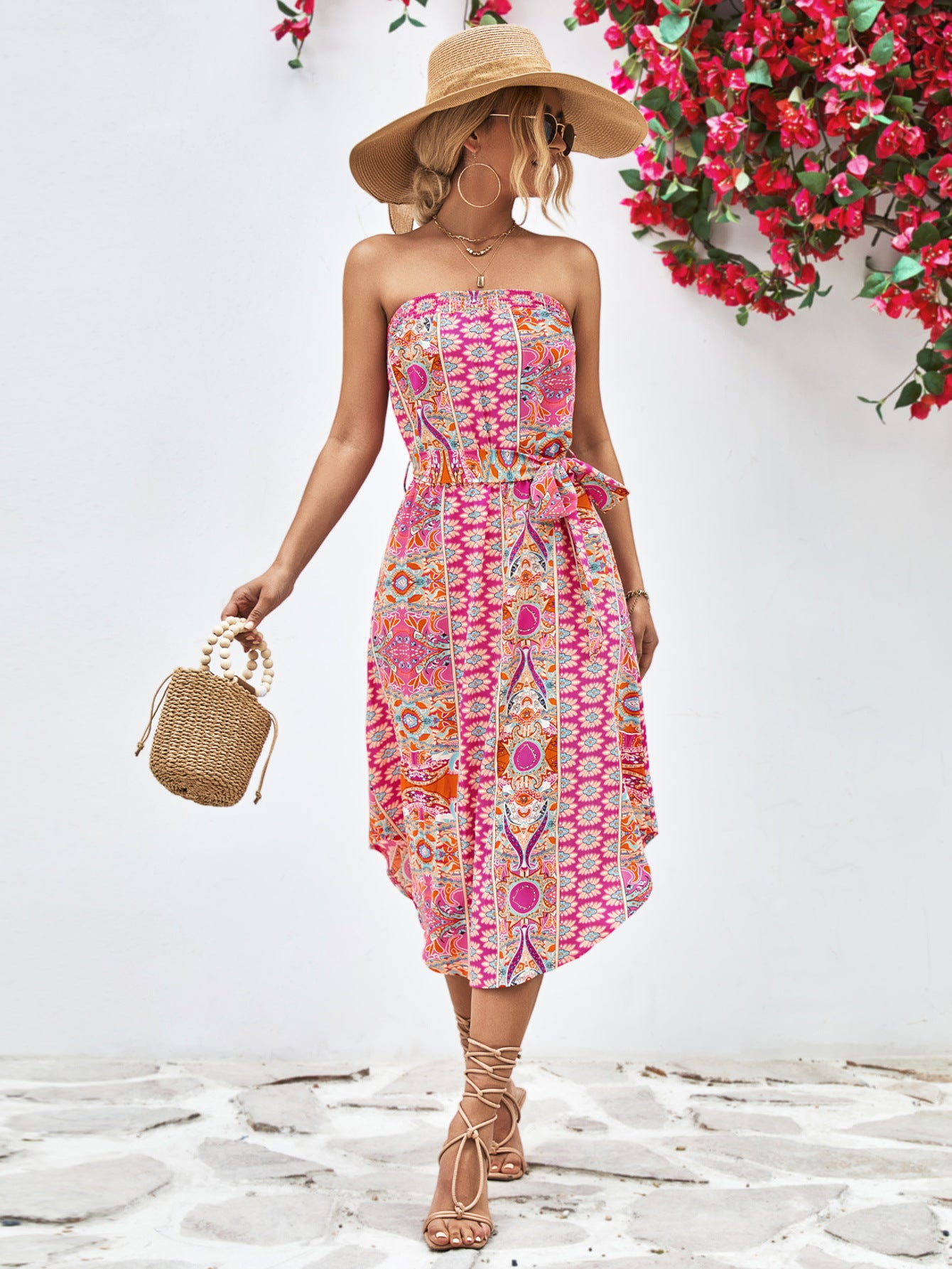 Hot pink strapless tie-belt dress with colorful geometric print, gathered waist, midi length