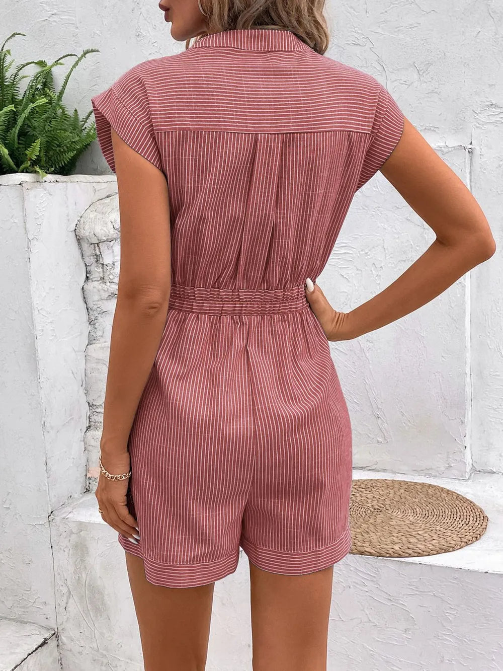 Striped notched tie-waist romper in dusty pink, back view with gathered waist