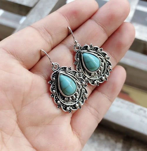 Turquoise teardrop dangle earrings, oval bezel, silver-tone bead and swirl details