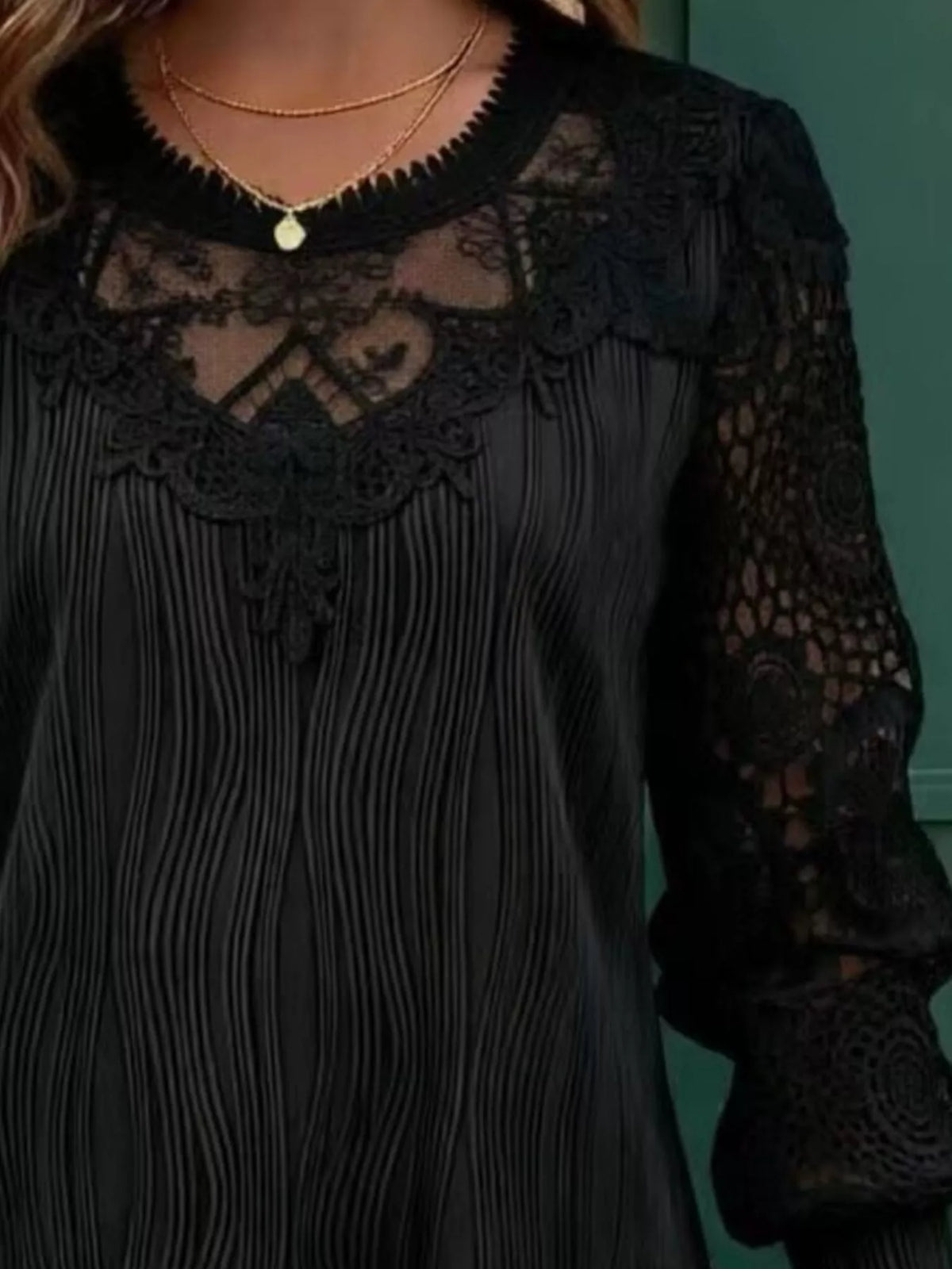 Black lace long-sleeve blouse with scalloped neckline and textured crochet shoulder panels
