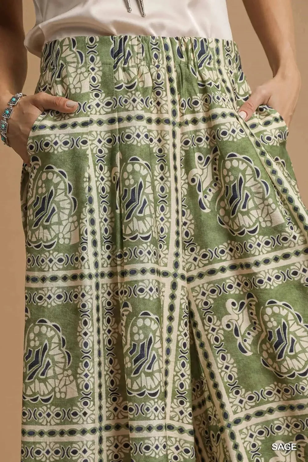 Sage green bohemian print pants with pockets, pattern detail and border