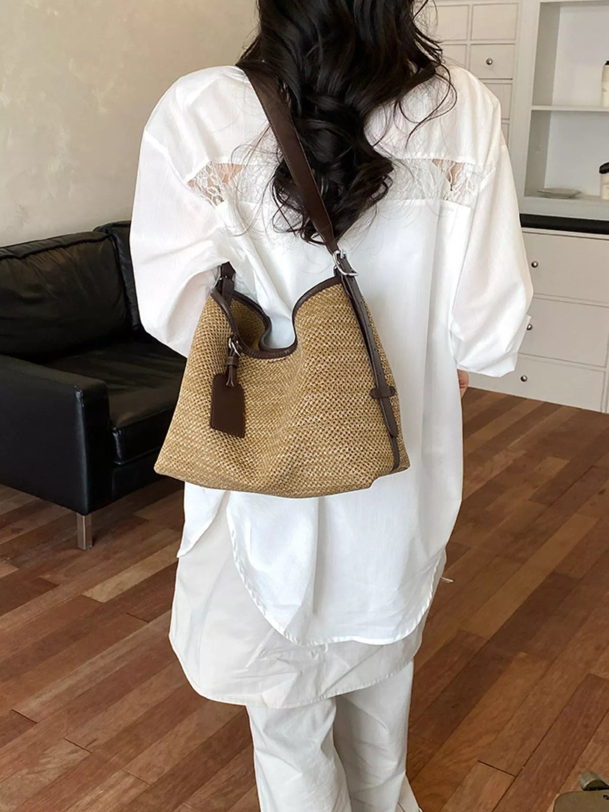 Camel woven shoulder bag with dark leather trim and hanging charm