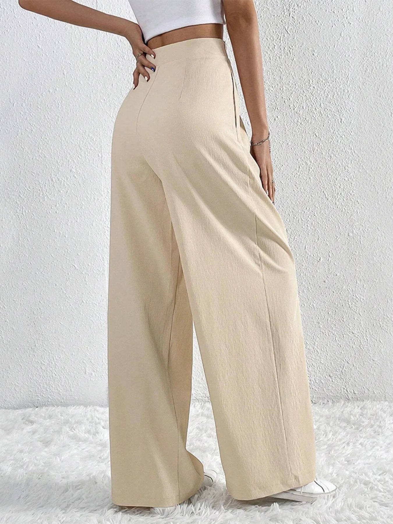 Beige wide-leg pants with ruched front and V-waist opening