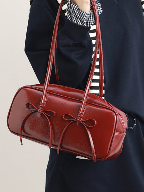 Red bow-decor shoulder bag with double top handles and zippered top