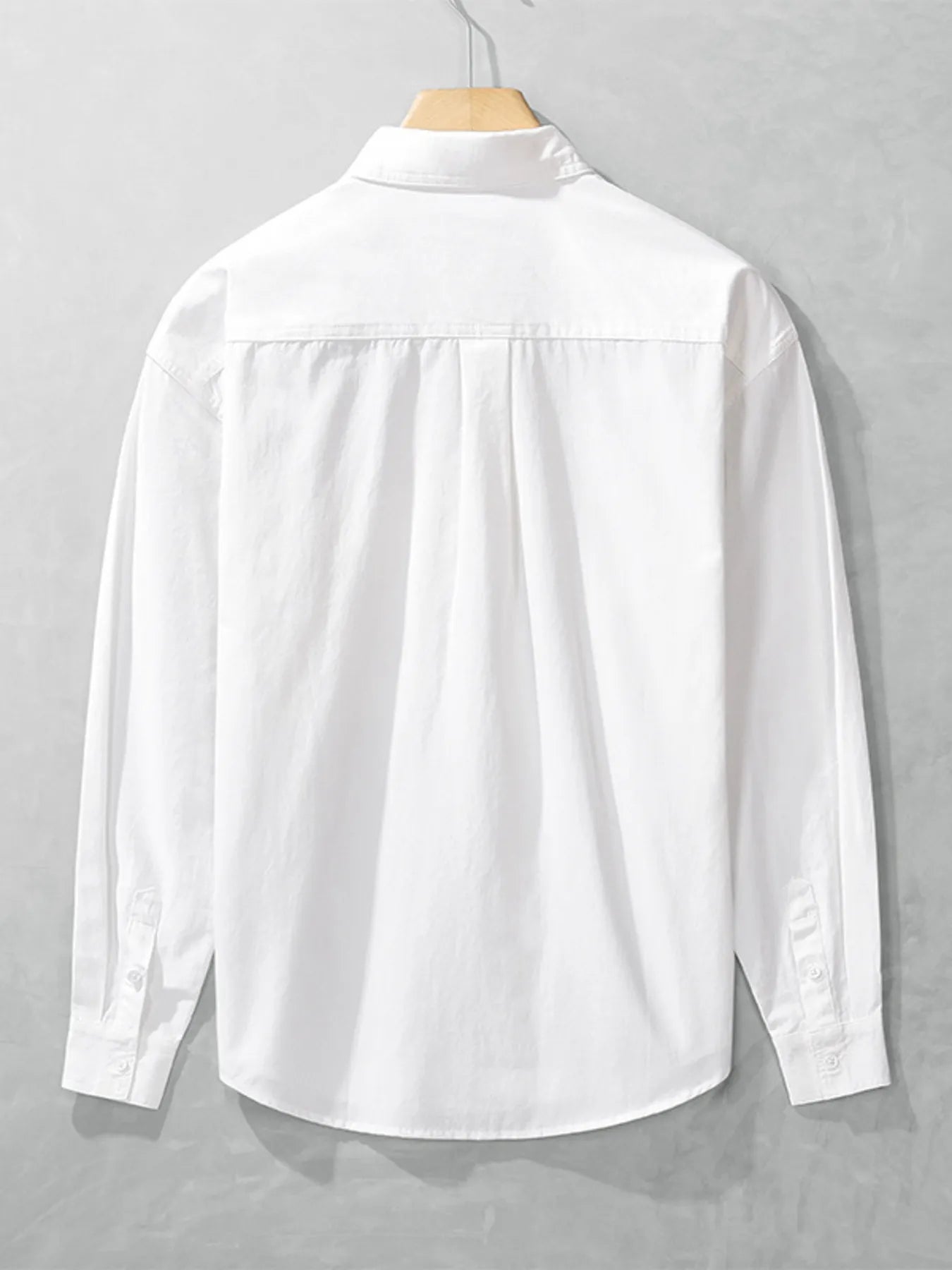 White button-up long sleeve shirt back view with button placket and yoke seam.