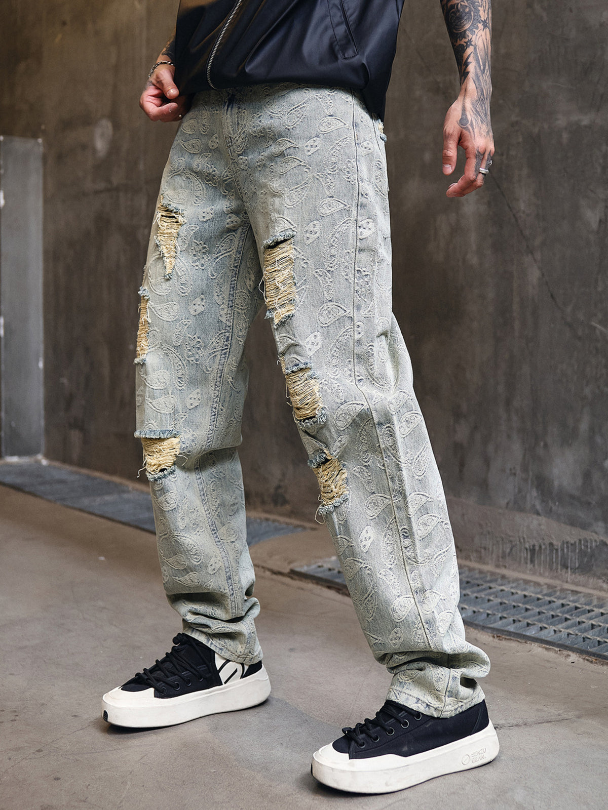 Light wash wide-leg distressed cotton jeans with ripped knees and relaxed fit