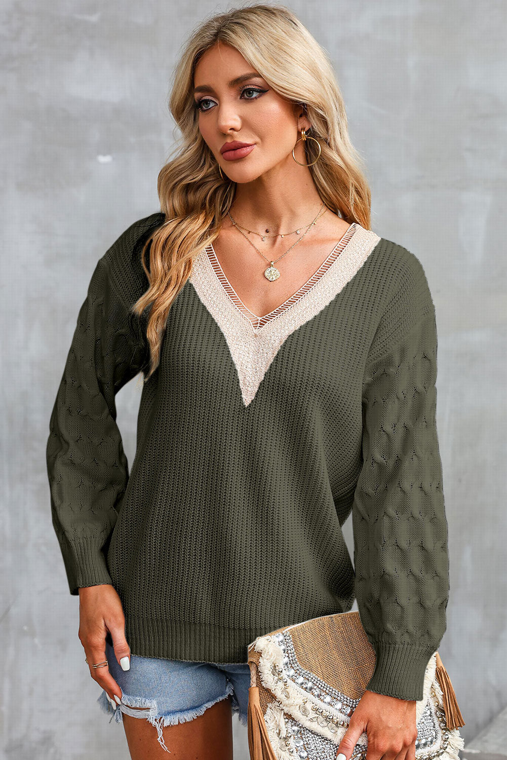 Army green V-neck sweater with cream contrast neckline and long puff sleeves