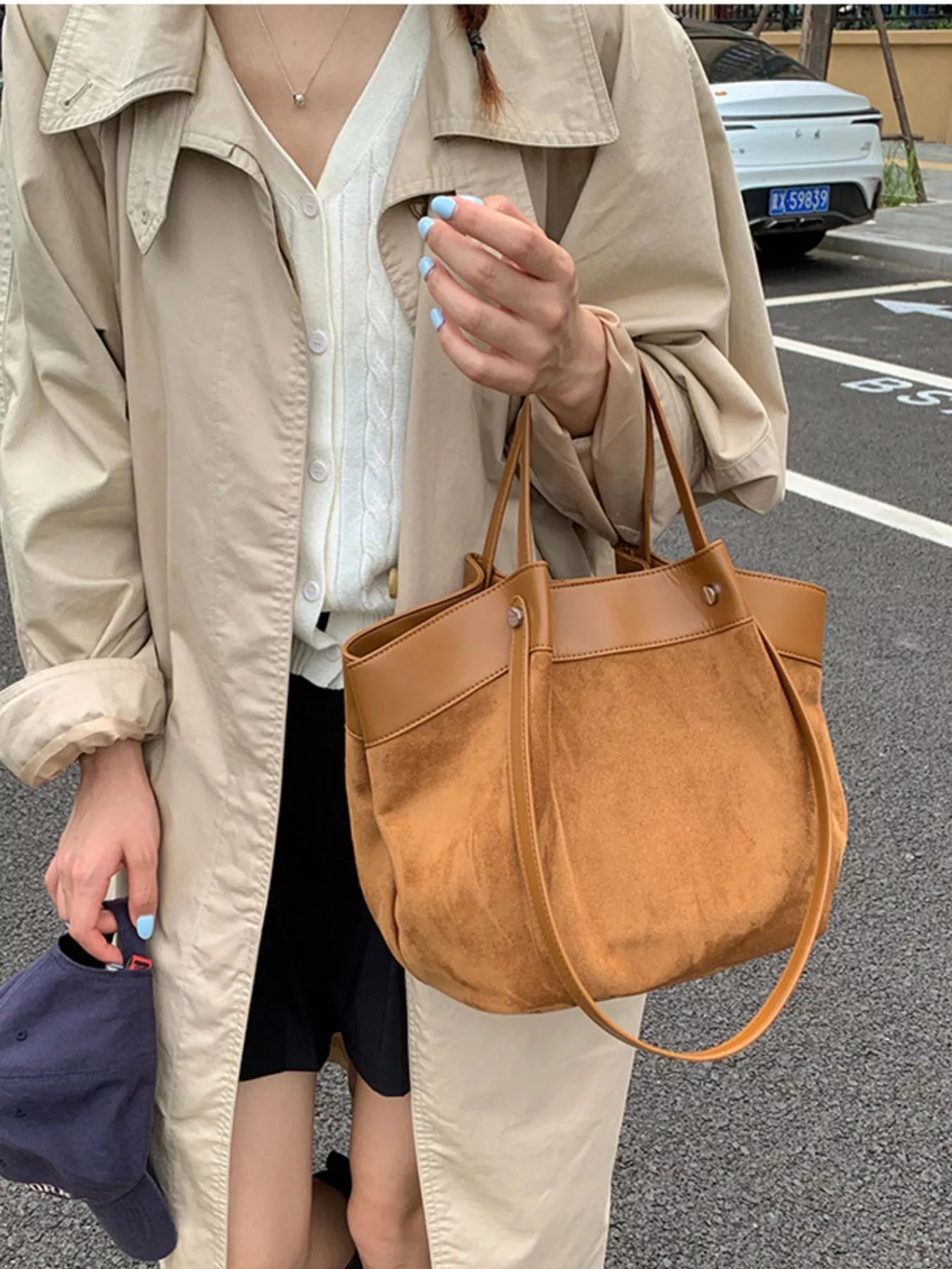 Brown suede shoulder bag with leather handles and front seam detail