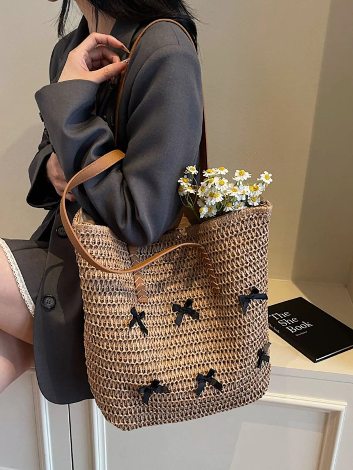 Caramel woven straw tote bag with bow applique trim and long leather-look straps