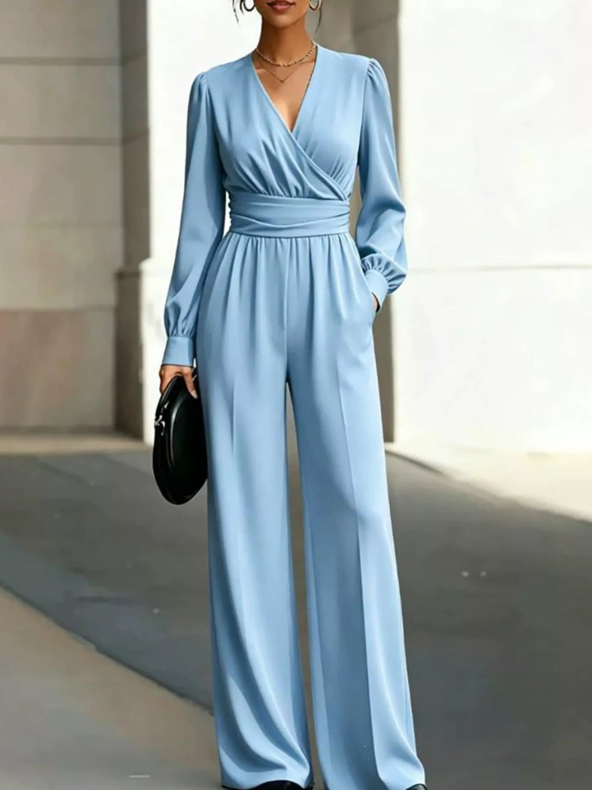 Light blue surplice wide-leg jumpsuit with long sleeves and side pockets
