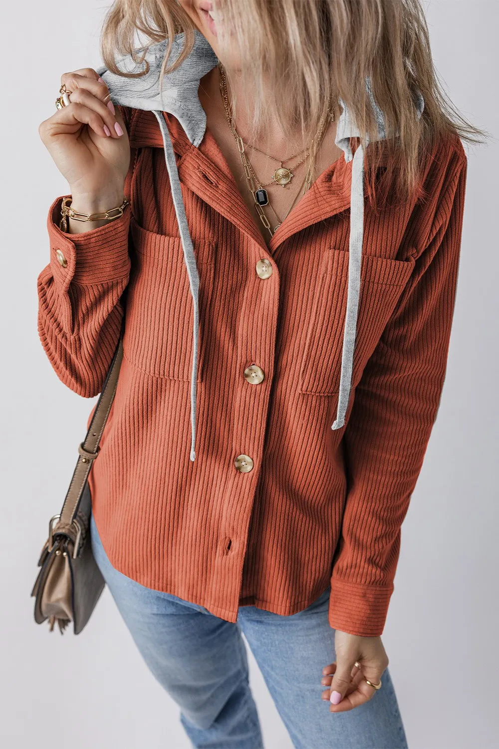 Orange-red ribbed hooded button-up jacket with long sleeves, gray drawstring hood.