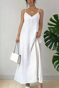 White spaghetti-strap V-neck maxi dress with subtle texture and flowing skirt