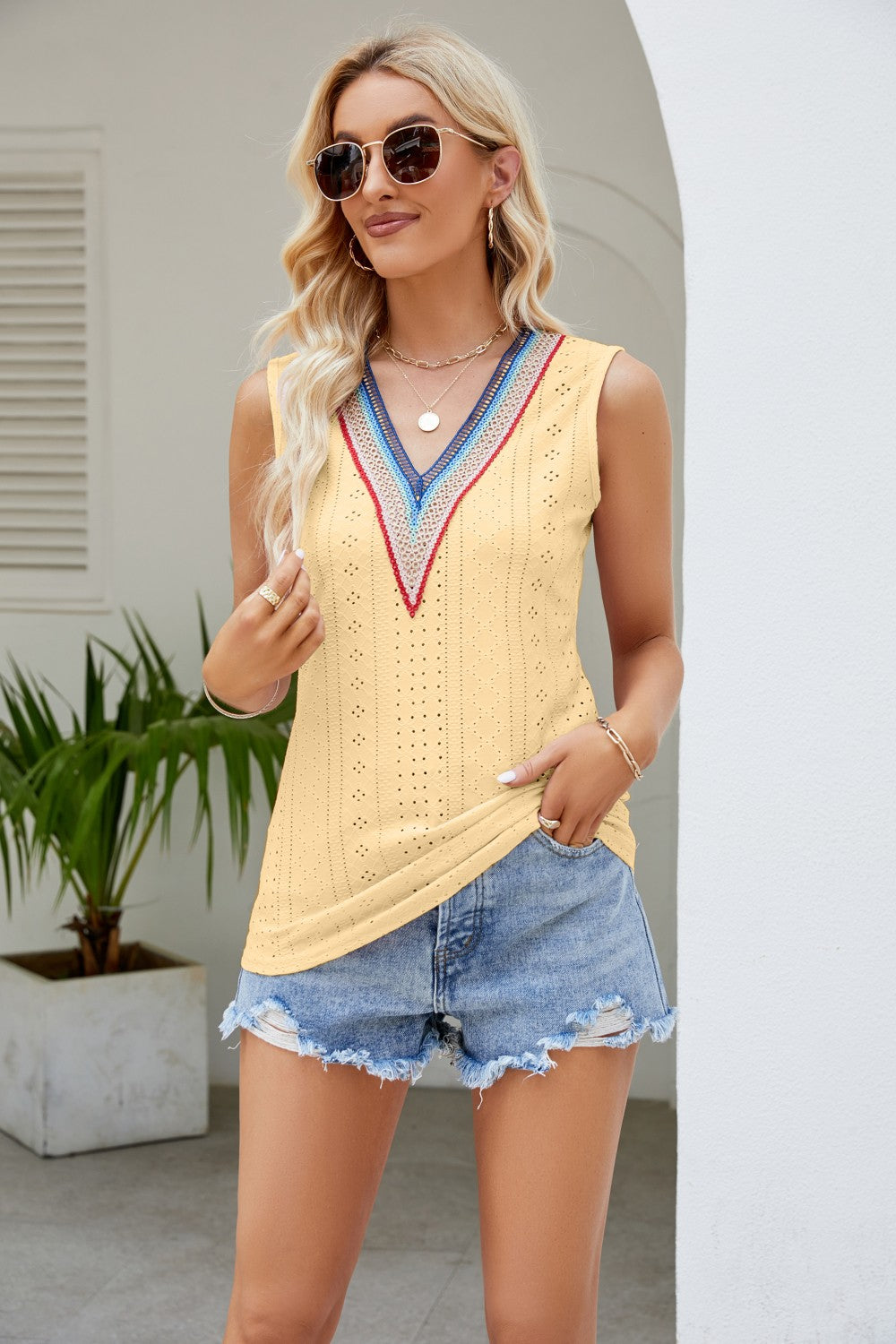 Light yellow contrast V-neck eyelet tank top with blue-pink trim and V-shaped neckline