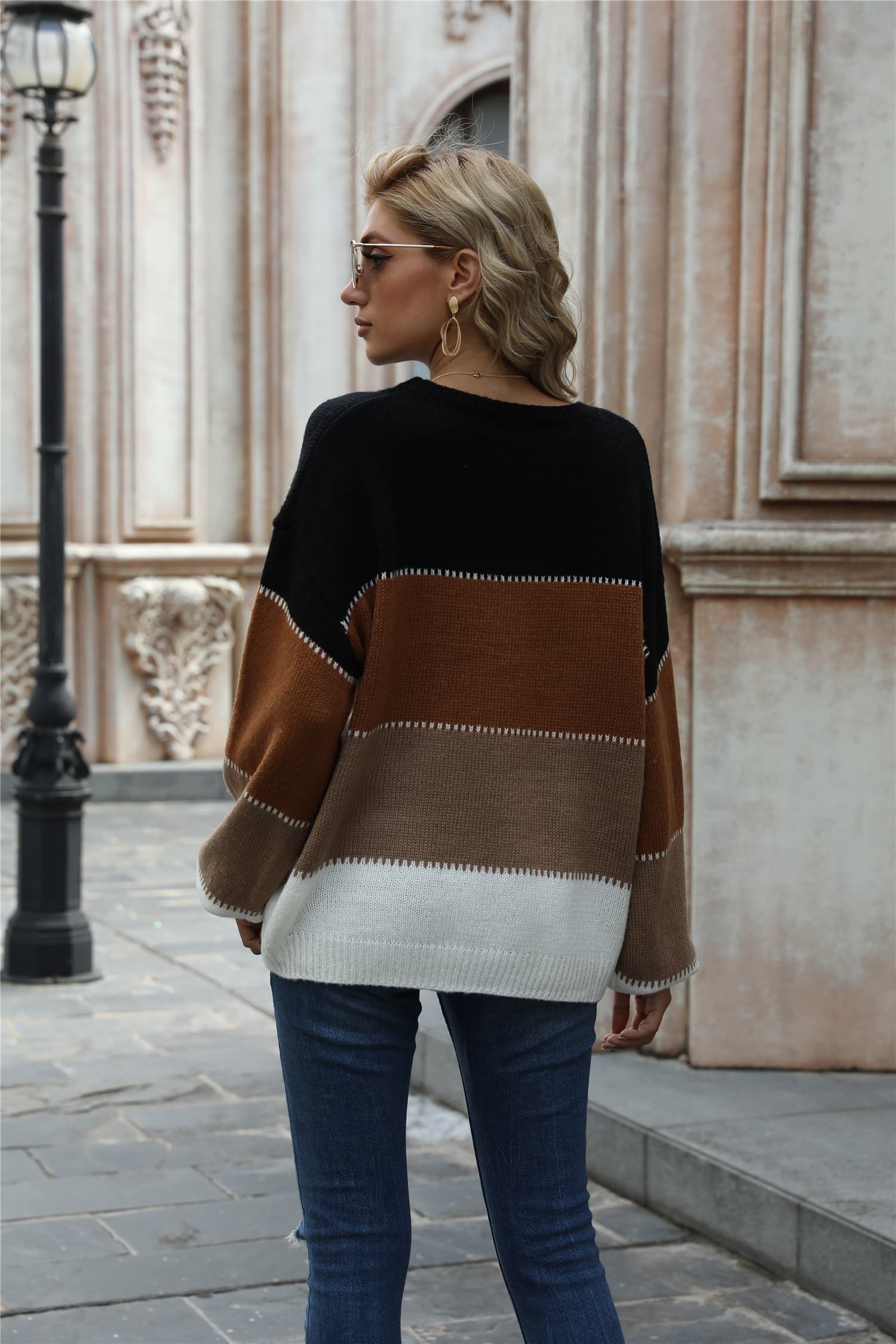 Color-block round-neck sweater, black, tan, and light gray bands, long sleeves.