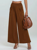 Brown high-waisted wide-leg pants with elastic waist and side pockets