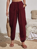 Burgundy drawstring cargo joggers with cargo pockets and cuffed ankles